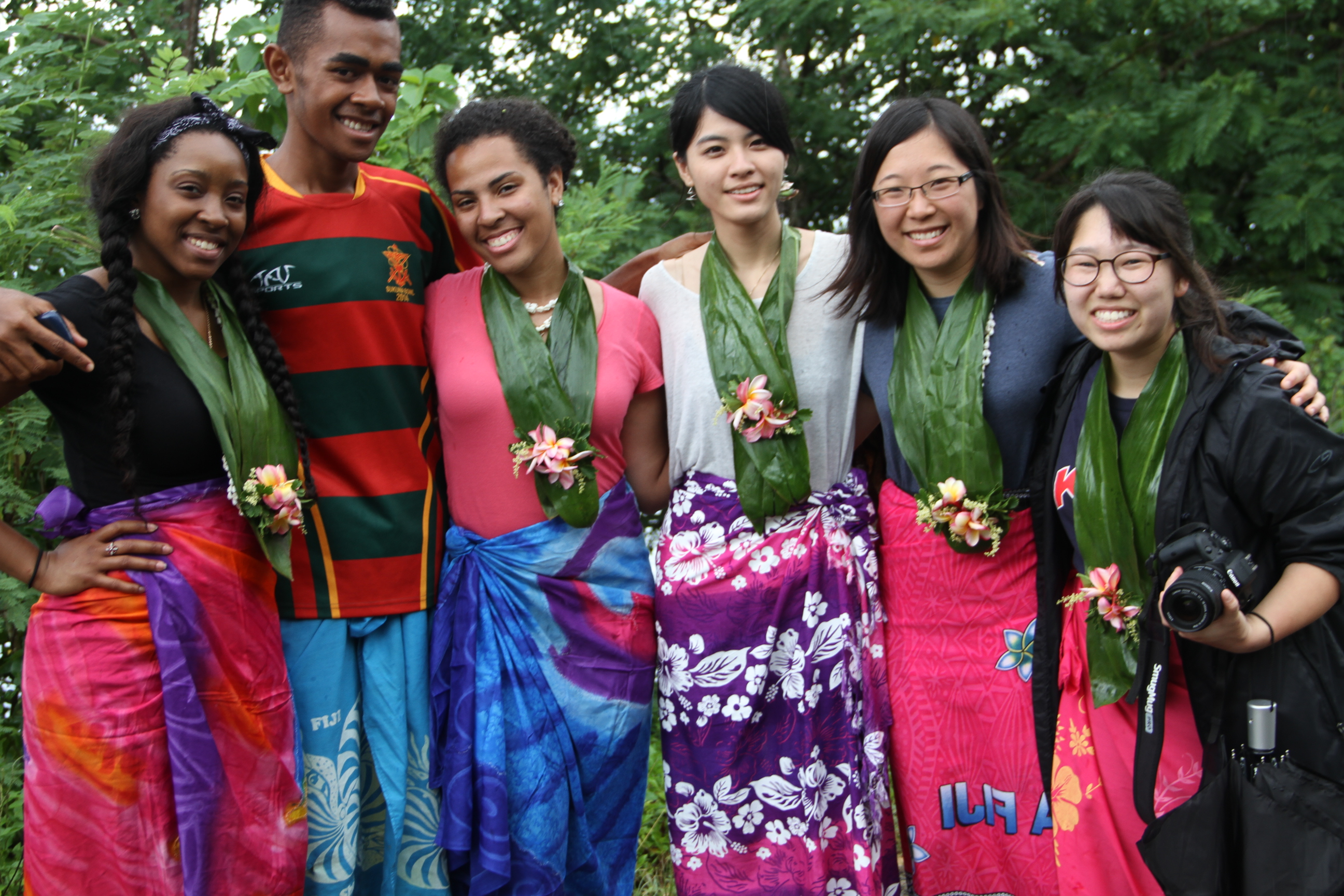 Students and a villager wearing sulus