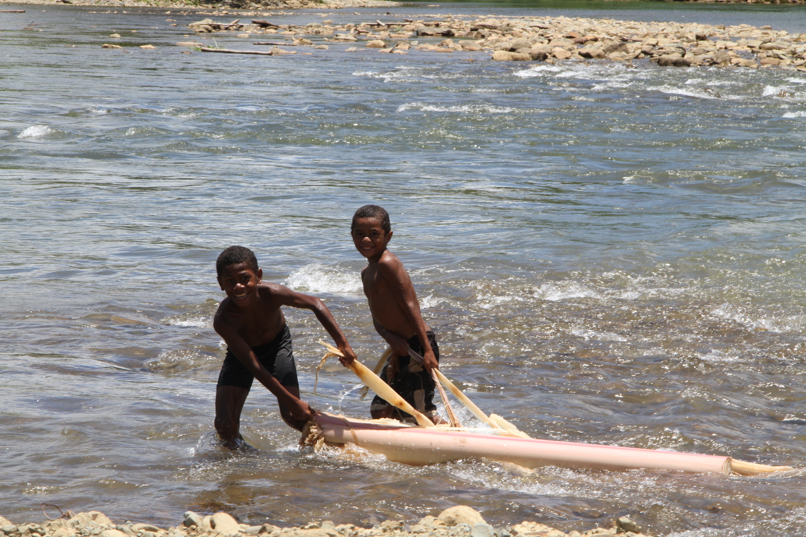 Young boys playing in river