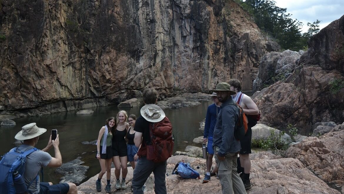 Photo of Emma and friends in front of river at bottom of canyon.