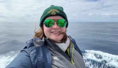 Previous Student, Kennedy Fast, on the Viewing Deck of the M/V Ushuaia ship with the ocean behind