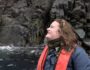 Student, Kennedy Fast, on one of the Zodiac day excursions with rocky cliff face behind
